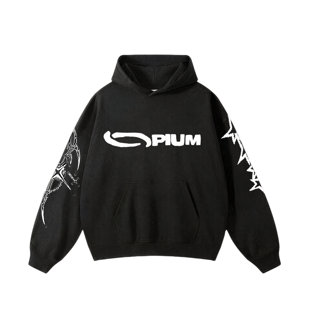 Front view of an oversized washed black hoodie featuring the word 'OPIUM' in a stylized white font on the chest and gothic tribal graphics printed down both sleeves.